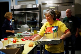 Lake Street Church volunteers prepare and serve dinner for the guests at Hilda's Place through Sustenance Connection.